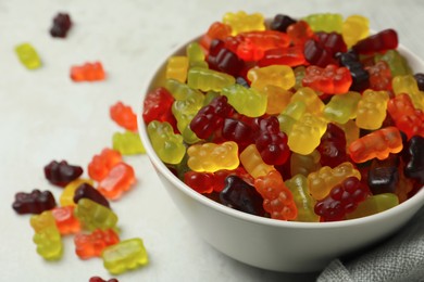 Photo of Delicious gummy bear candies on light table, closeup