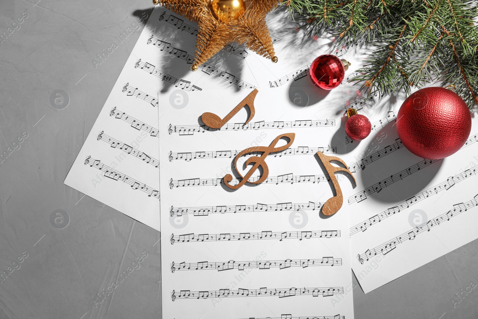 Photo of Composition with wooden music notes and decorations on grey background, top view