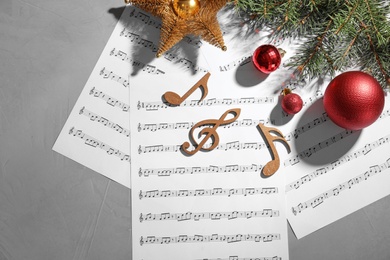 Composition with wooden music notes and decorations on grey background, top view