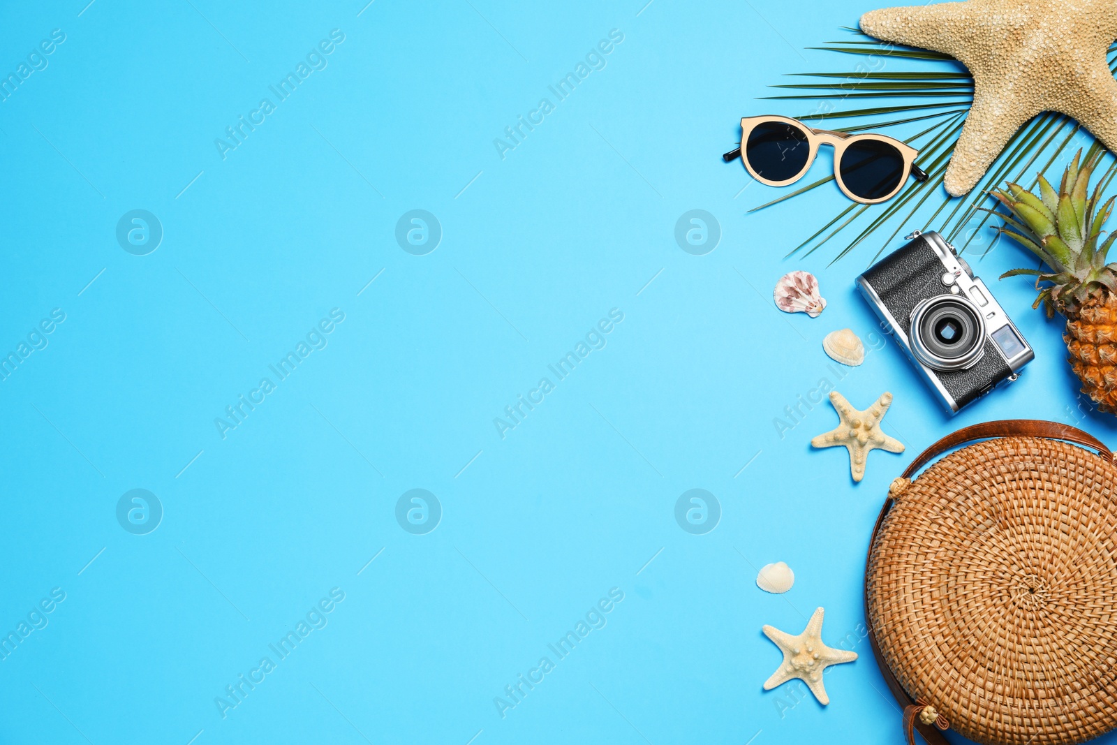 Photo of Flat lay composition with beach accessories on color background, space for text