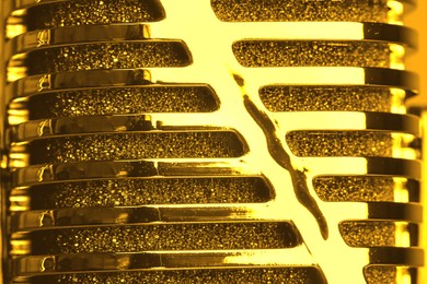 Image of Shiny golden retro microphone as background, closeup