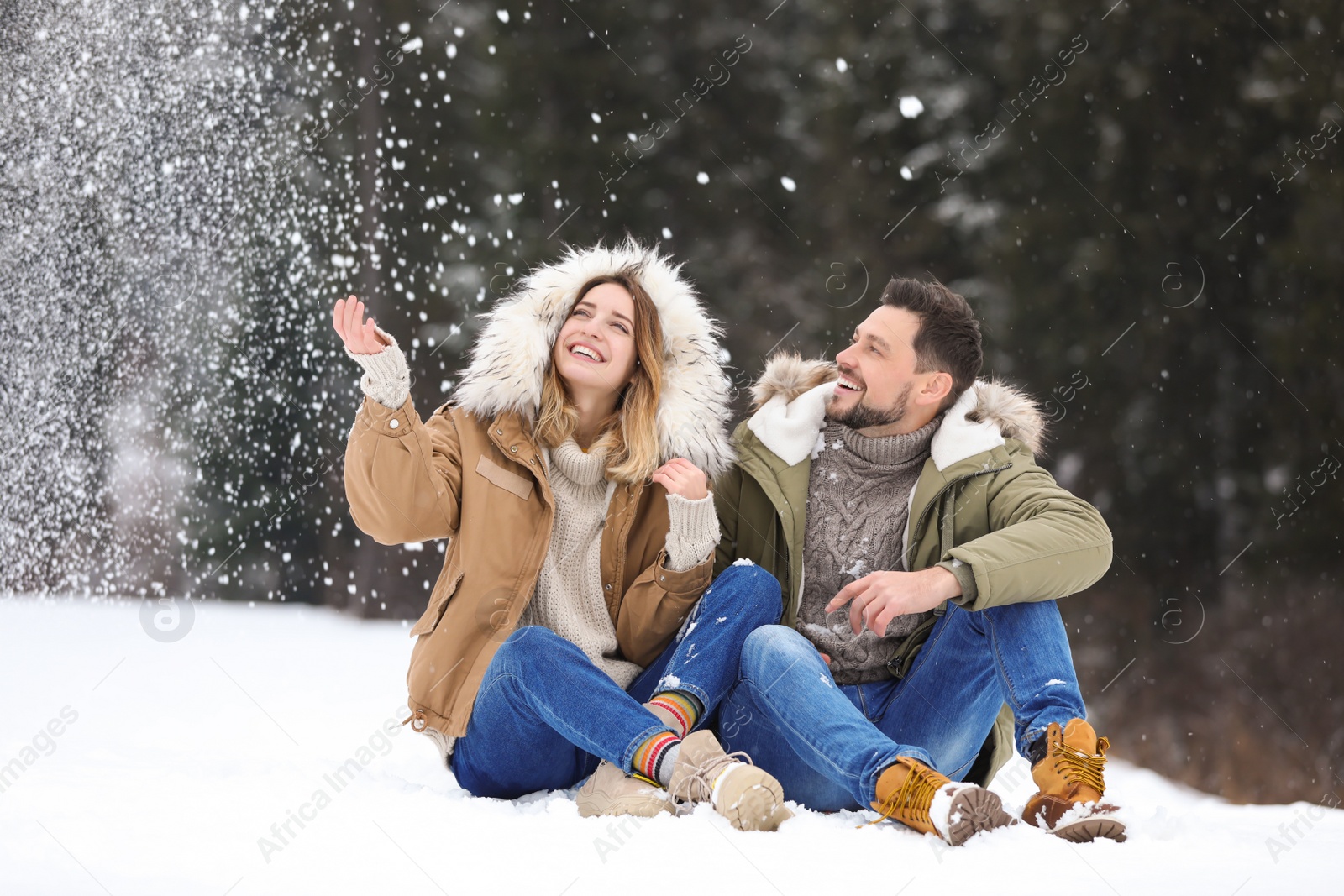 Photo of Couple spending time outdoors on snowy day. Winter vacation