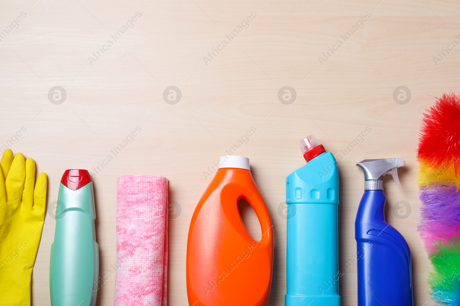 Photo of Flat lay composition with cleaning supplies on wooden background