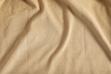 Crumpled beige fabric as background, top view