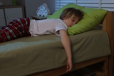Photo of Little boy snoring while sleeping in bed at night