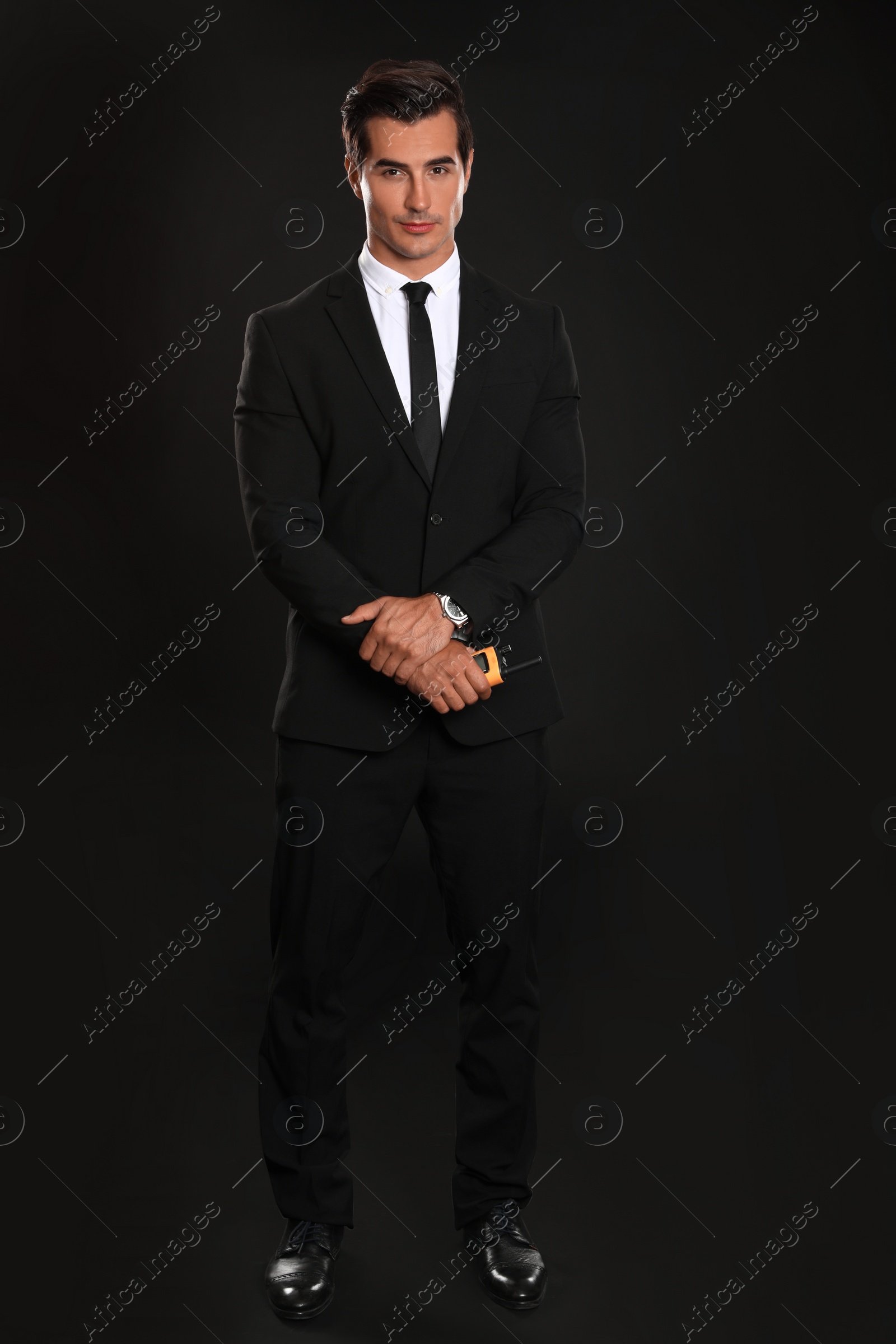 Photo of Male security guard in uniform on dark background