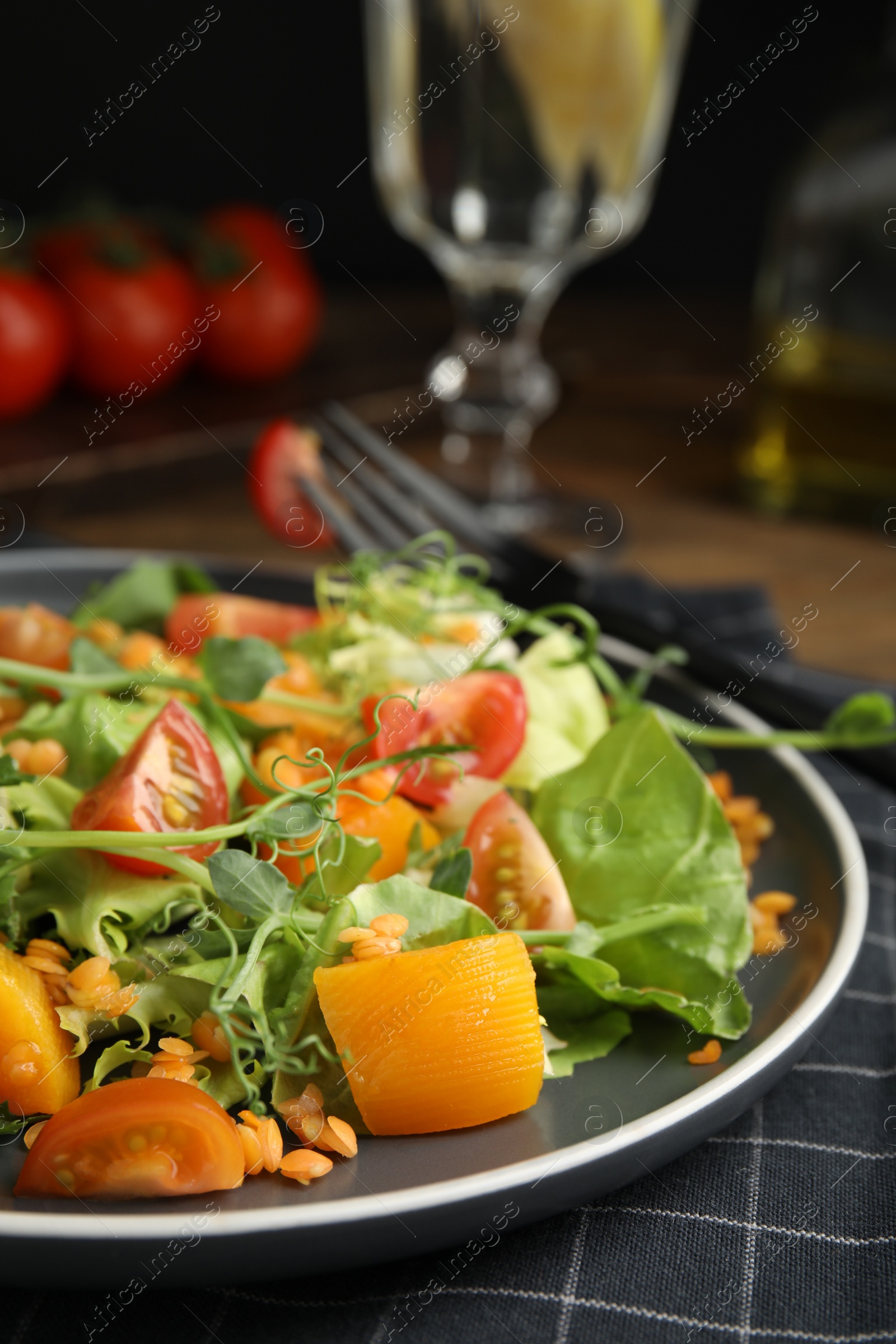 Photo of Delicious salad with lentils and vegetables served on table, closeup