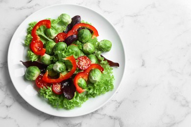 Tasty salad with Brussels sprouts on white marble table, top view. Space for text