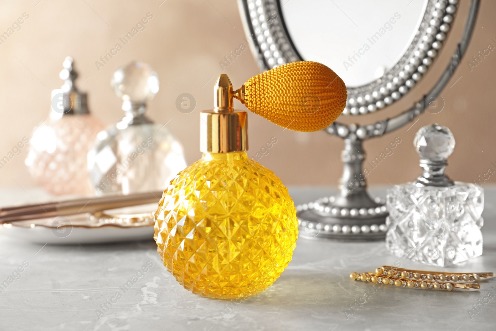 Photo of Different elegant perfume bottles on dressing table