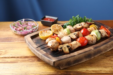 Photo of Delicious shish kebabs with grilled vegetables served on wooden table. Space for text