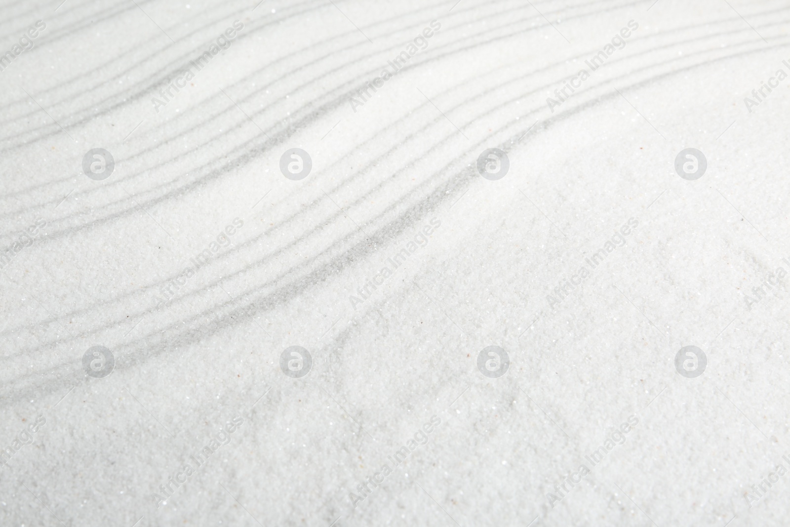 Photo of Zen rock garden. Wave pattern on white sand