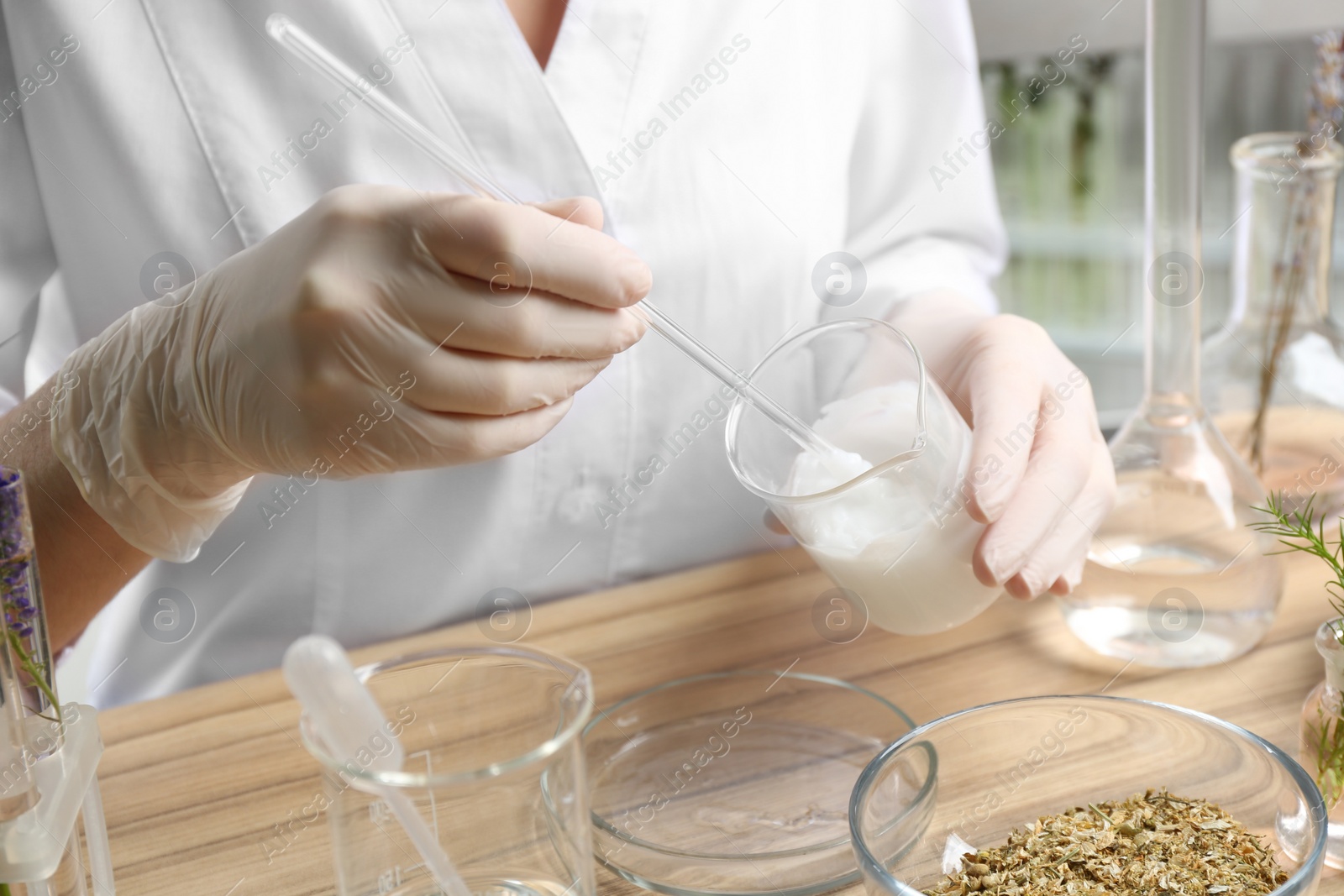 Photo of Scientist developing cosmetic product in laboratory, closeup