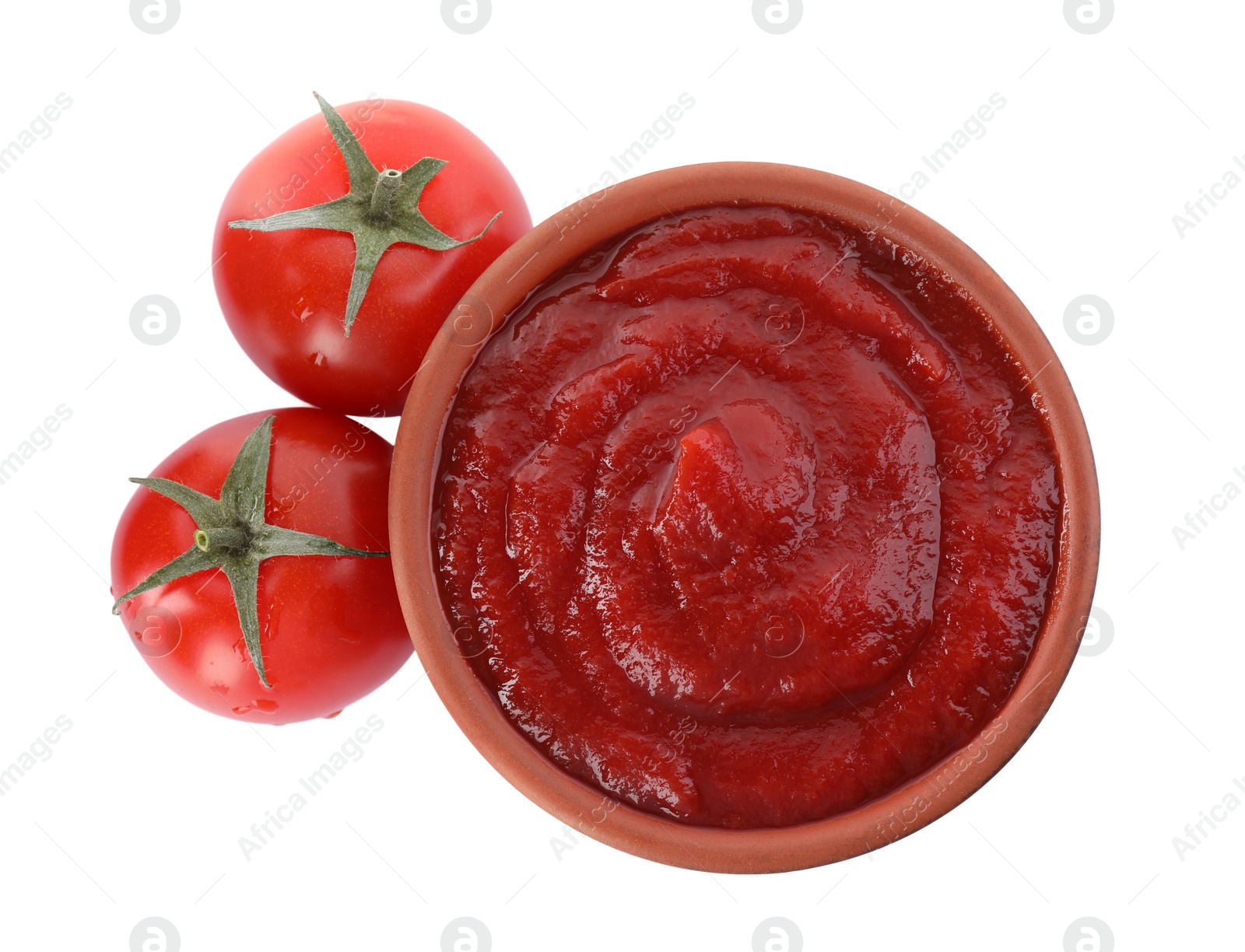 Photo of Tasty ketchup in bowl and fresh tomatoes isolated on white, top view