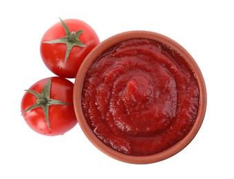 Photo of Tasty ketchup in bowl and fresh tomatoes isolated on white, top view