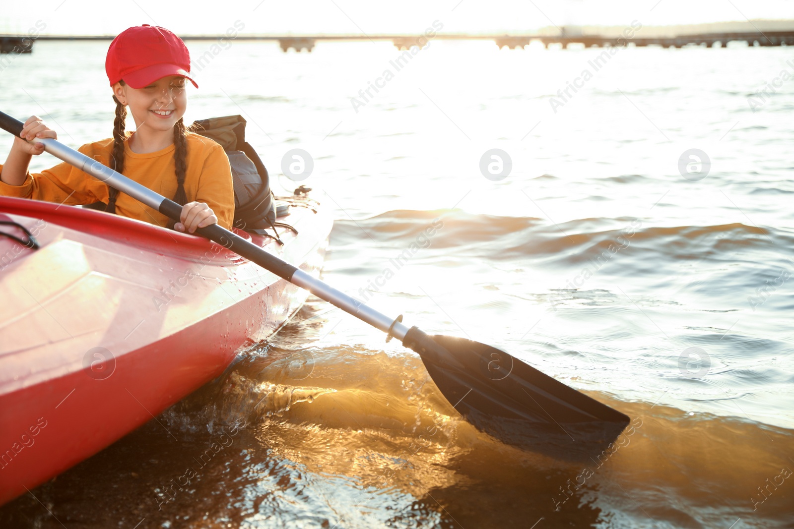 Photo of Happy girl kayaking on river. Summer camp activity