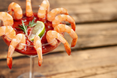 Photo of Delicious shrimp cocktail with tomato sauce, closeup