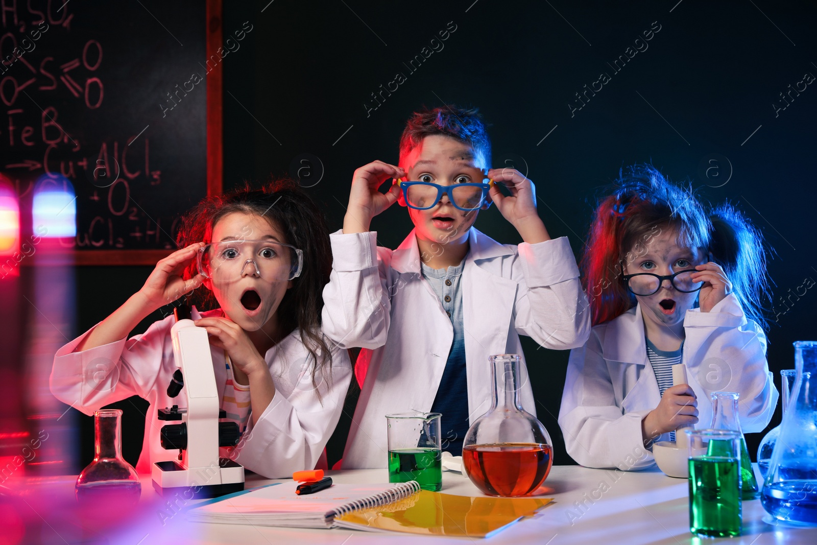 Photo of Children doing chemical research in laboratory. Dangerous experiment