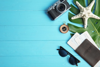 Photo of Flat lay composition with passport and camera on color wooden background, space for text