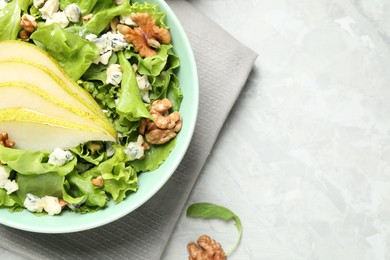 Photo of Tasty salad with pear slices on light grey table, flat lay. Space for text
