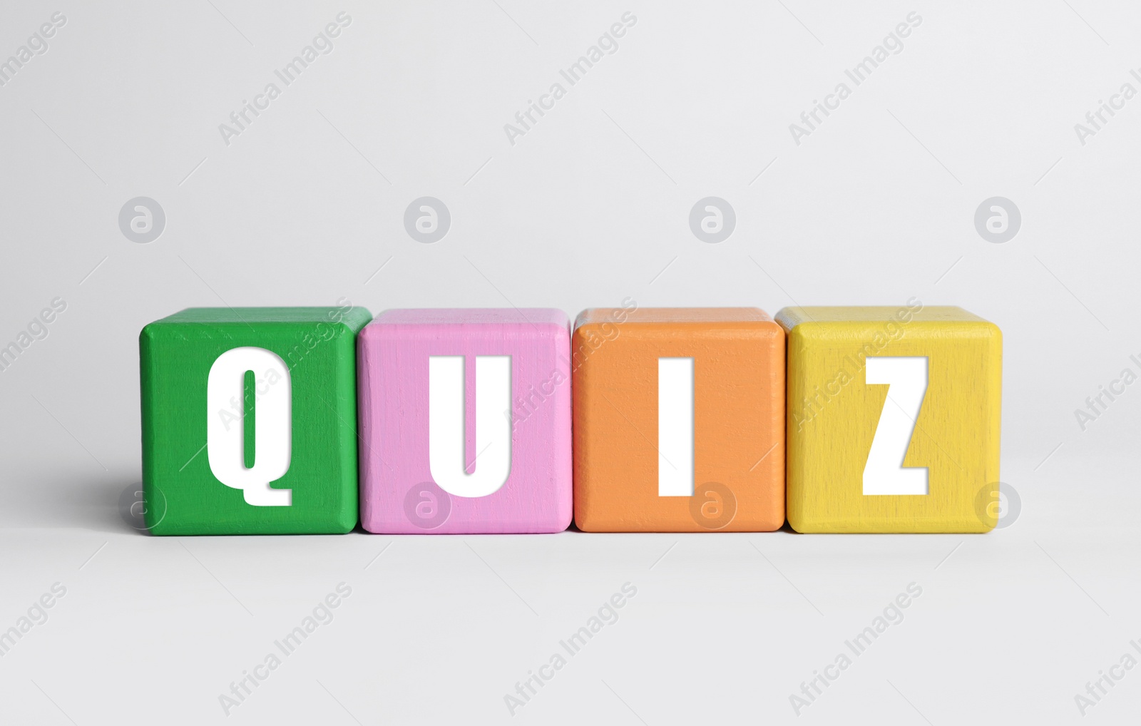 Photo of Colorful cubes with word Quiz on white background