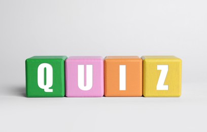 Photo of Colorful cubes with word Quiz on white background