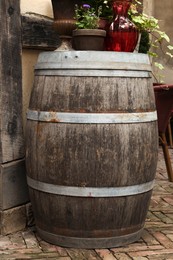 Traditional wooden barrel and beautiful houseplants outdoors