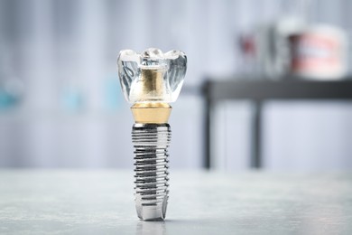 Photo of Educational model of dental implant on light table indoors, closeup