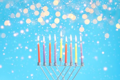 Image of Hanukkah celebration. Menorah with burning candles on light blue background with blurred lights, closeup