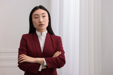 Portrait of notary with crossed arms in office. Space for text