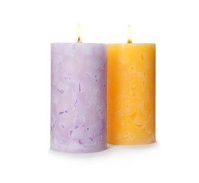 Photo of Alight color wax candles on white background