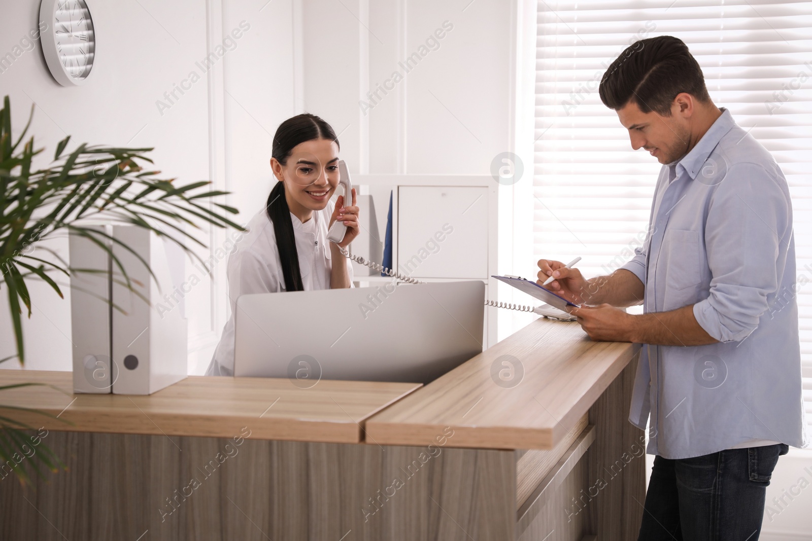 Photo of Nurse and patient at reception in hospital