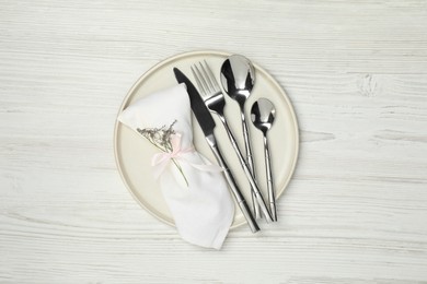 Stylish setting with elegant cutlery on white wooden table, top view