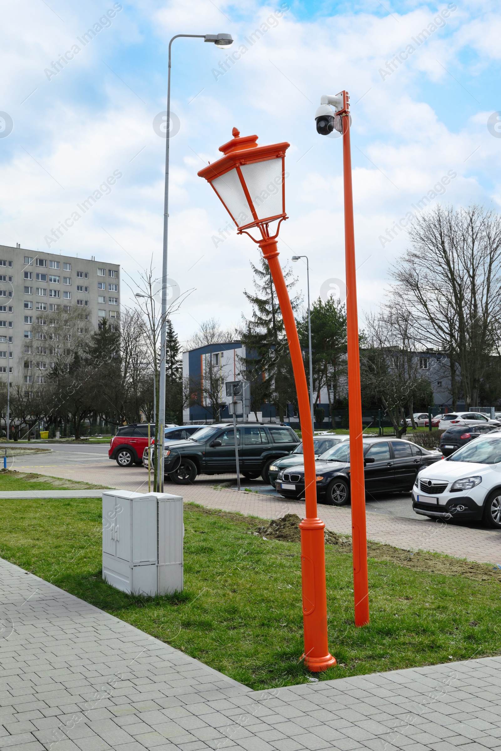 Photo of Funny red street lamp outdoors on sunny day