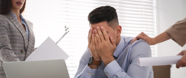 Image of Tired businessman stressing out at workplace in office. Banner design