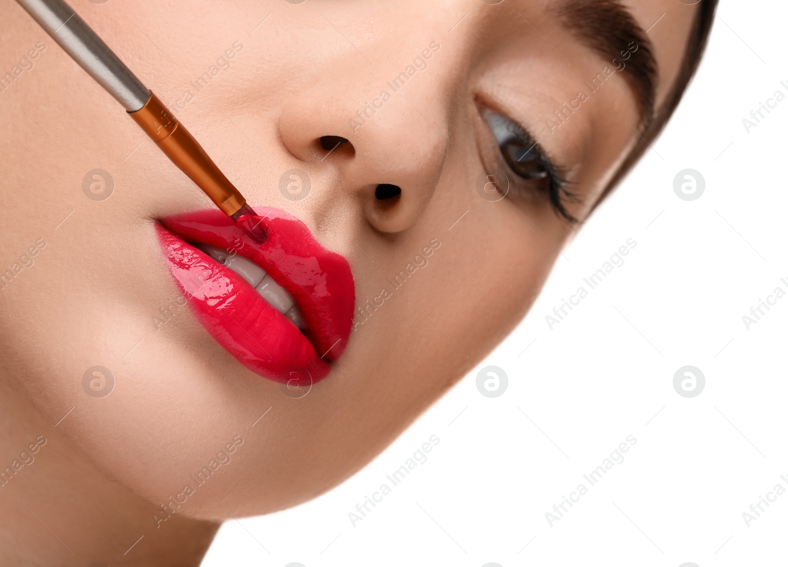 Photo of Woman applying lip gloss on white background, closeup