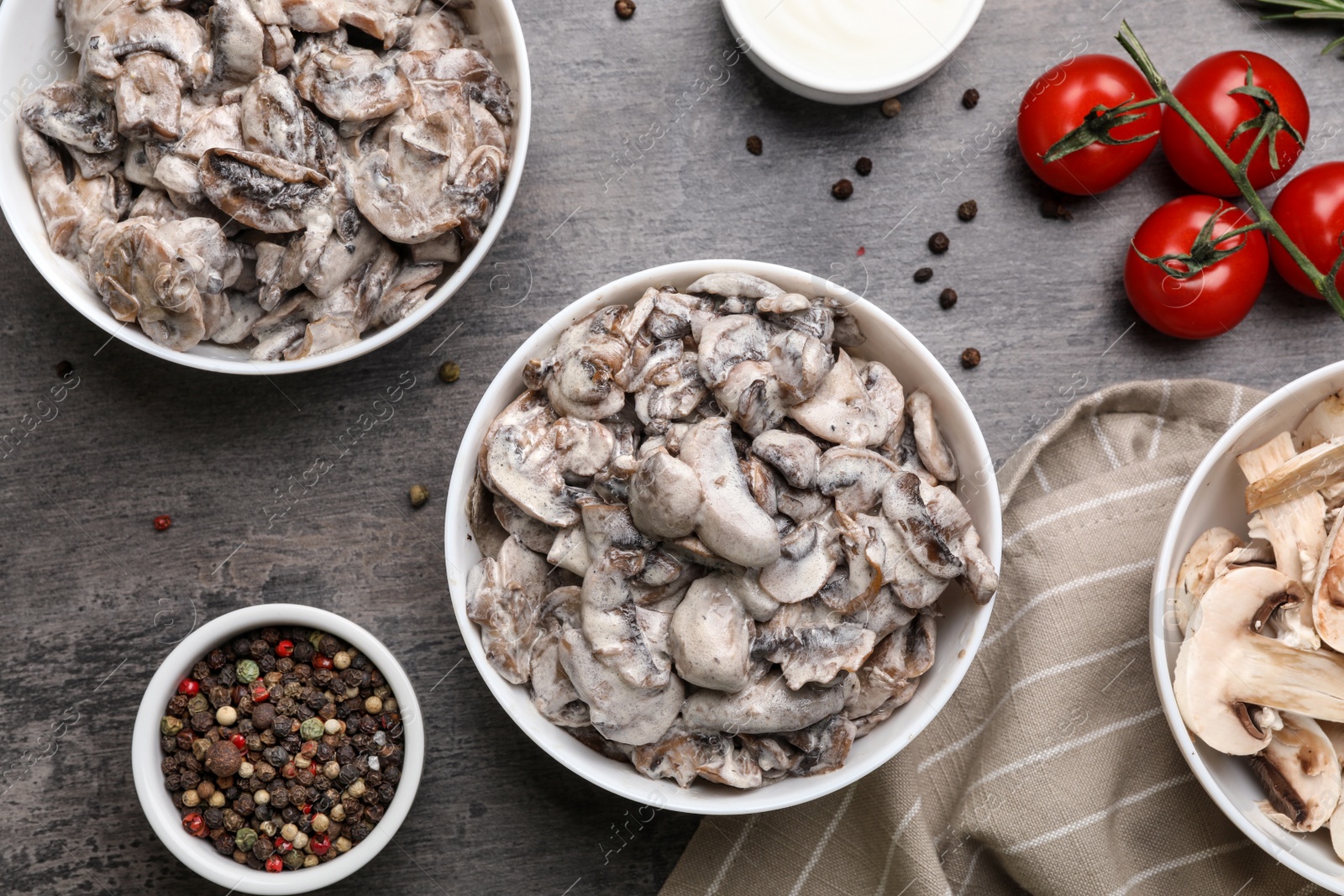 Photo of Flat lay composition with delicious mushrooms on grey table