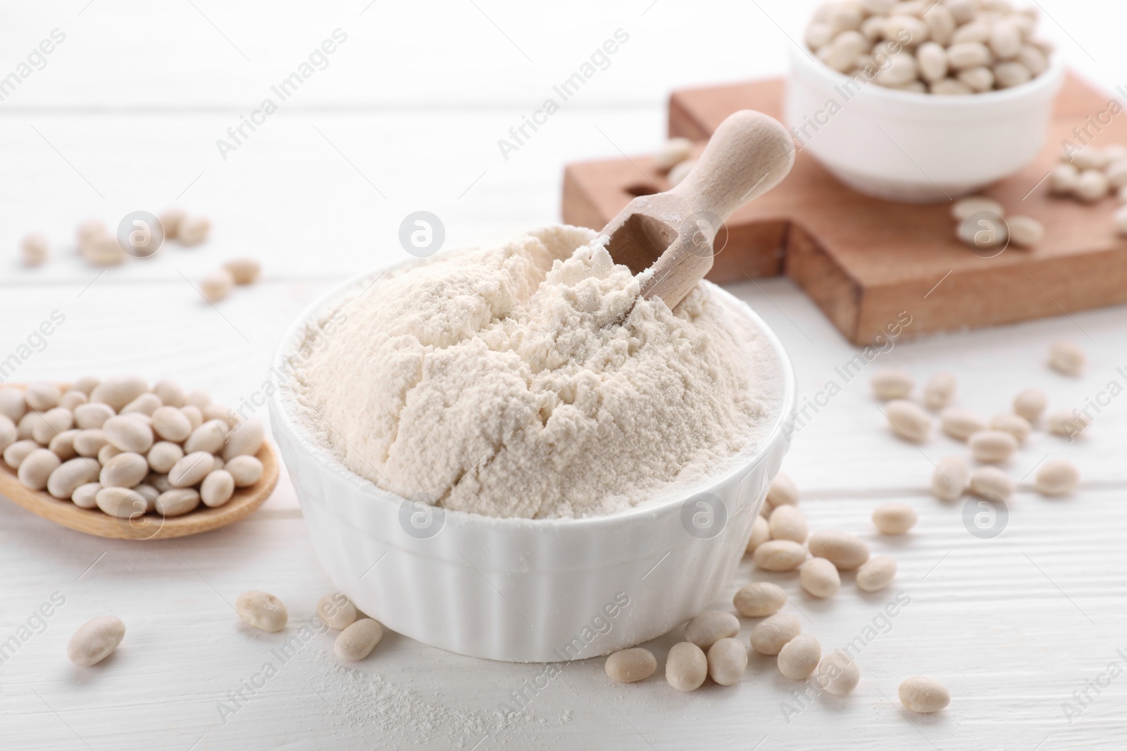 Photo of Kidney bean flour and seeds on white wooden table