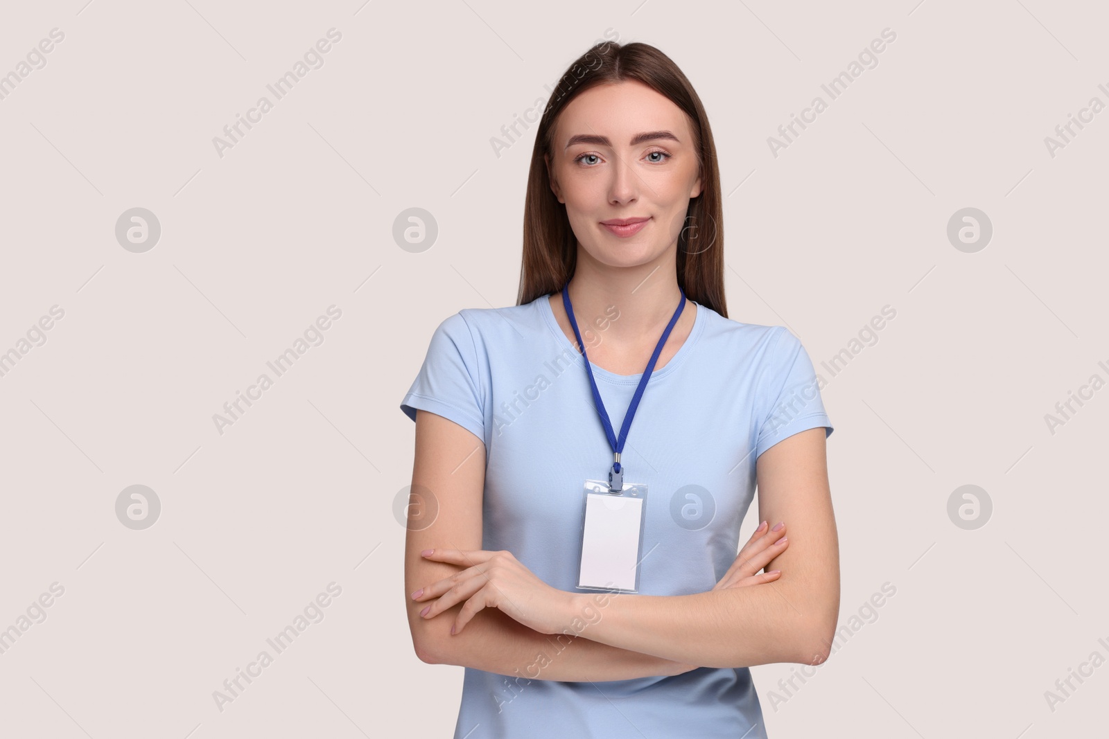 Photo of Woman with blank badge on grey background