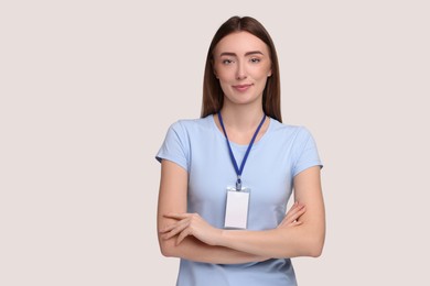 Photo of Woman with blank badge on grey background