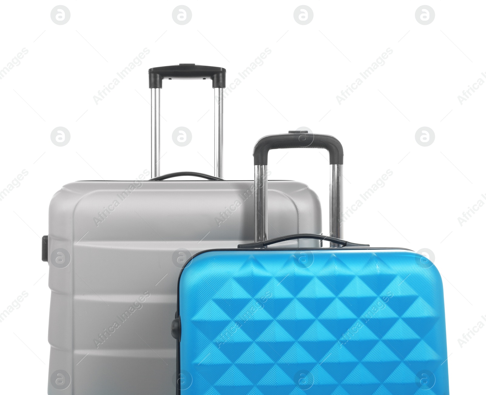 Photo of New suitcases packed for journey on white background