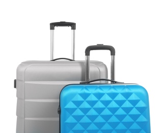 Photo of New suitcases packed for journey on white background