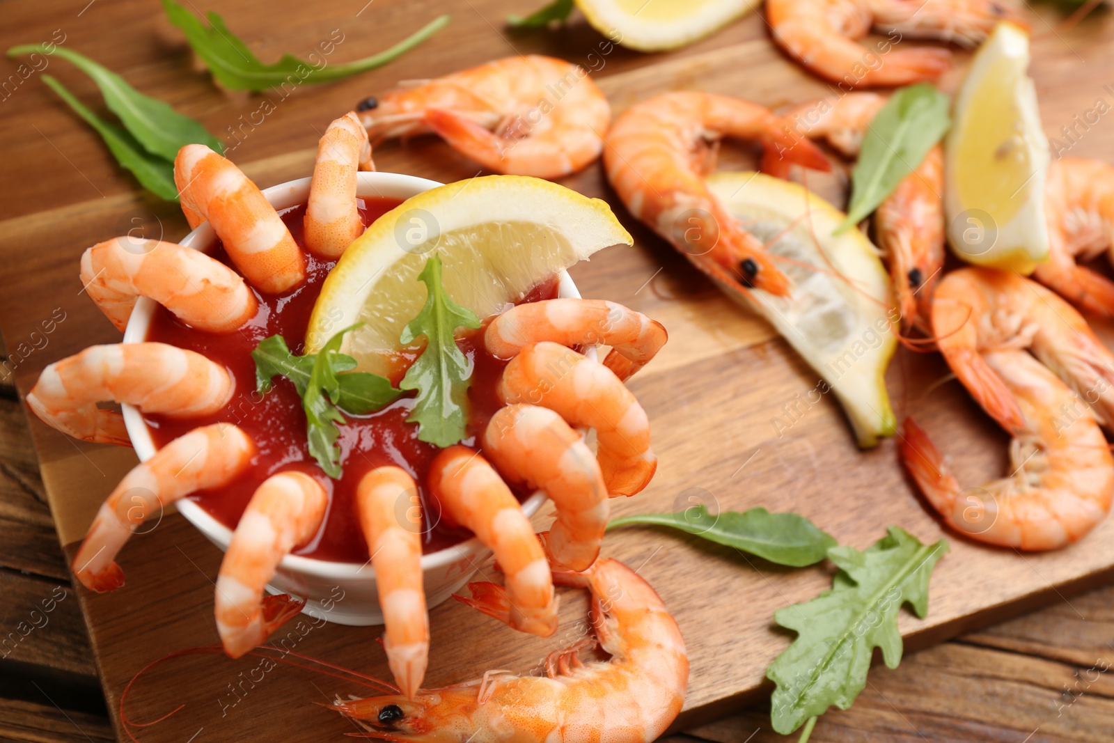 Photo of Delicious shrimp cocktail served on wooden board