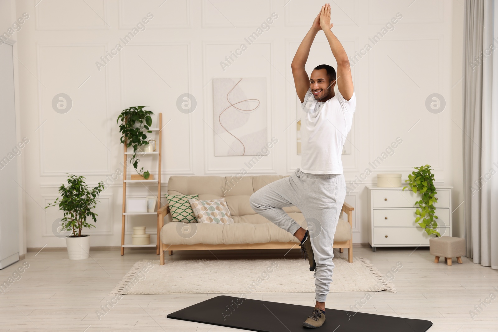 Photo of Man doing morning exercise on fitness mat at home