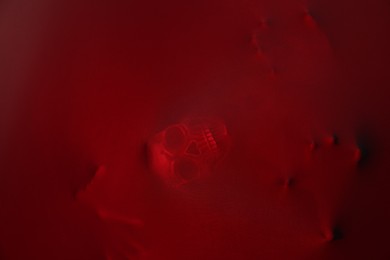 Photo of Silhouette of creepy ghost with skull behind red cloth