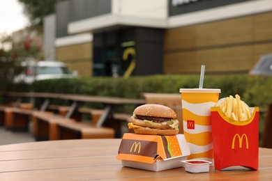 Photo of Lviv, Ukraine - October 9, 2023: McDonald's menu on wooden table outdoors, space for text