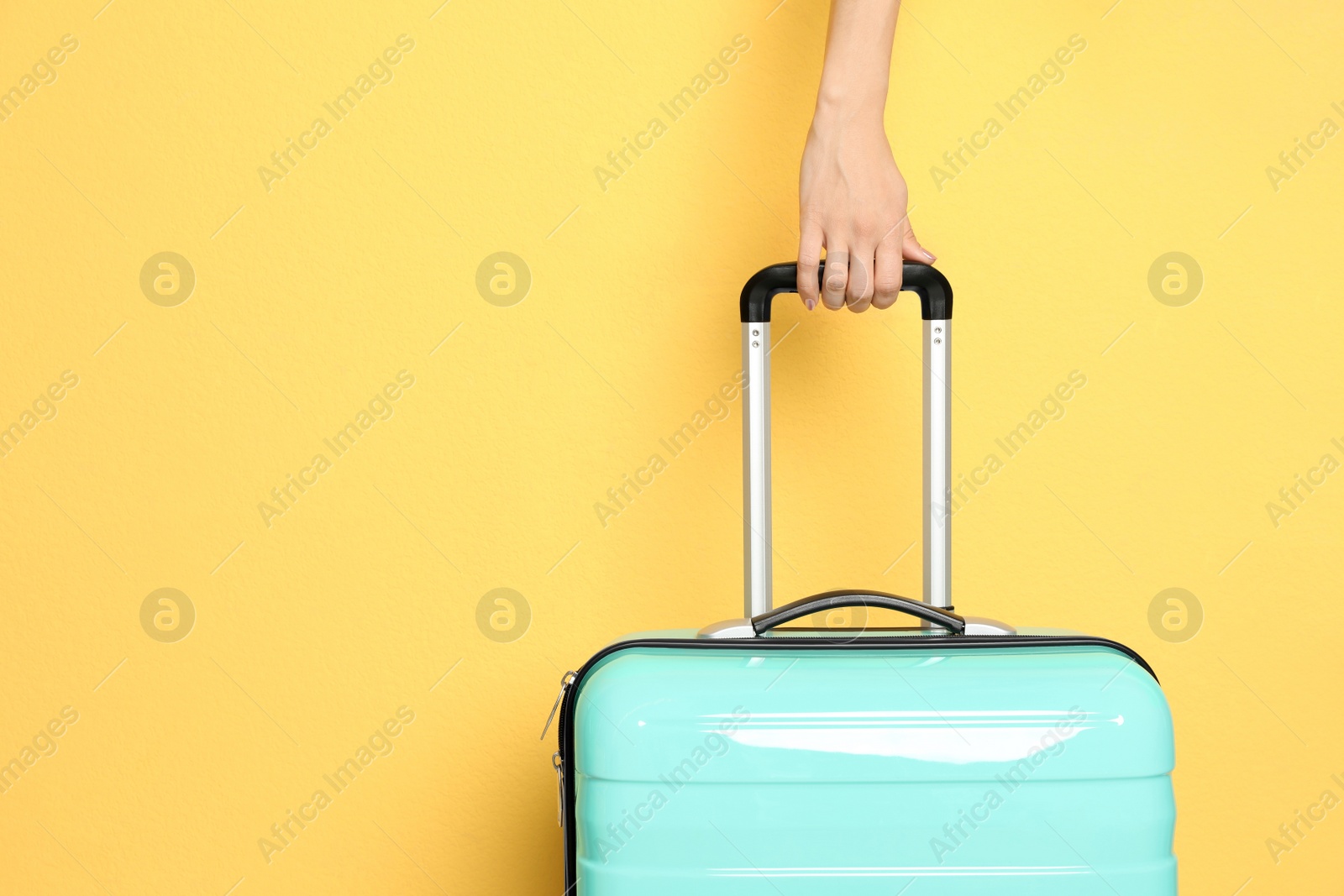 Photo of Woman with stylish suitcase against color background, closeup. Space for text