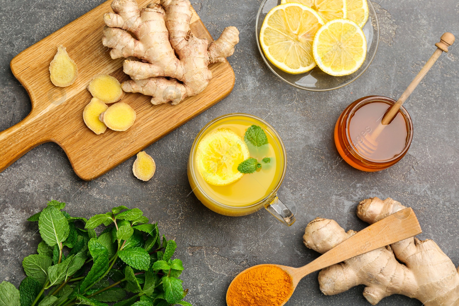 Photo of Flat lay composition with immunity boosting drink and ingredients on grey table