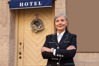 Photo of Portrait of smiling business owner near her hotel outdoors, space for text
