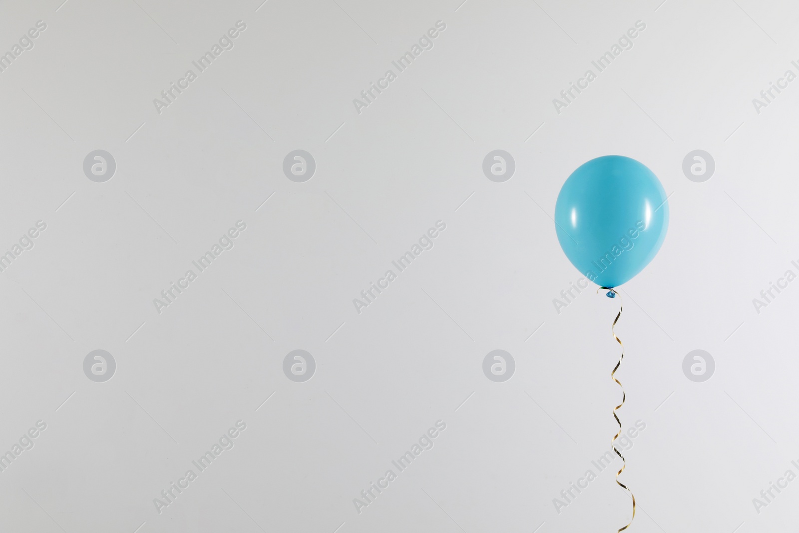 Photo of Bright balloon on light background, space for text. Celebration time