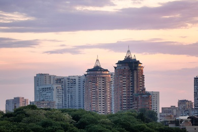 Photo of KYIV, UKRAINE - MAY 23, 2019: City district with modern buildings and trees at sunset